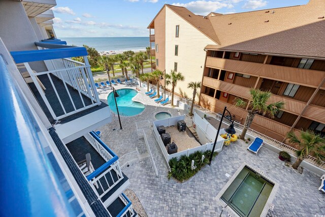 view of pool with a patio area and a water view