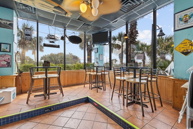 sunroom featuring ceiling fan