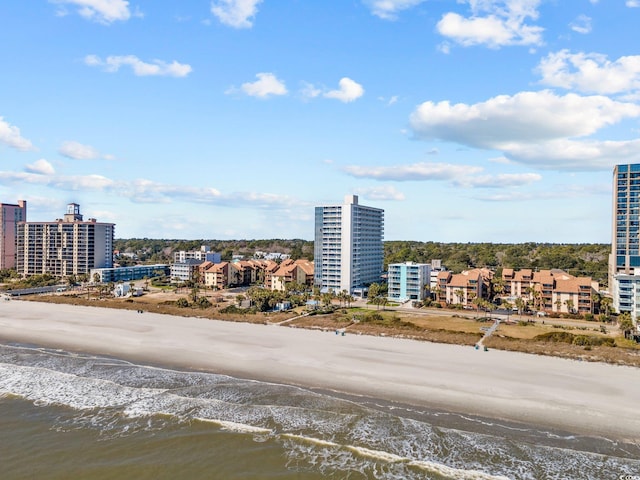 aerial view featuring a water view, a city view, and a view of the beach