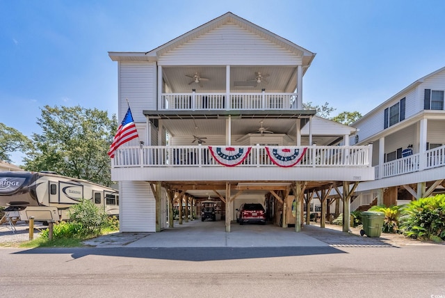 view of front of home featuring a porch, a carport, and ceiling fan