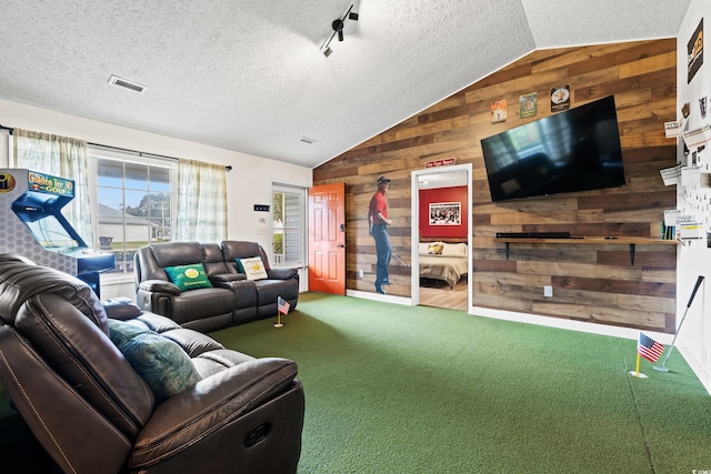 living room featuring wood walls, a textured ceiling, vaulted ceiling, and golf simulator