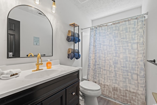 full bathroom with a textured ceiling, shower / tub combo, hardwood / wood-style floors, vanity, and toilet