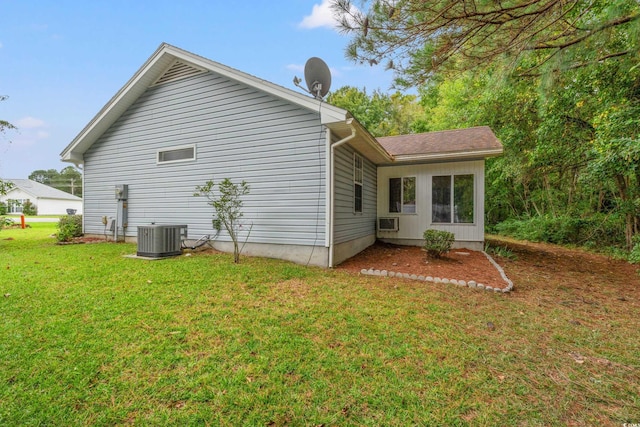 rear view of property featuring cooling unit and a yard