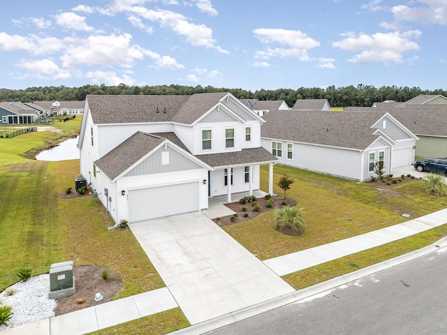 view of front of property featuring a front yard and a garage