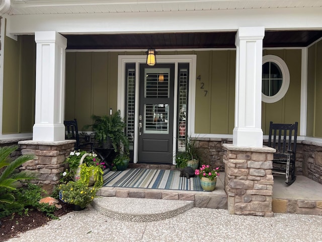 view of exterior entry featuring covered porch