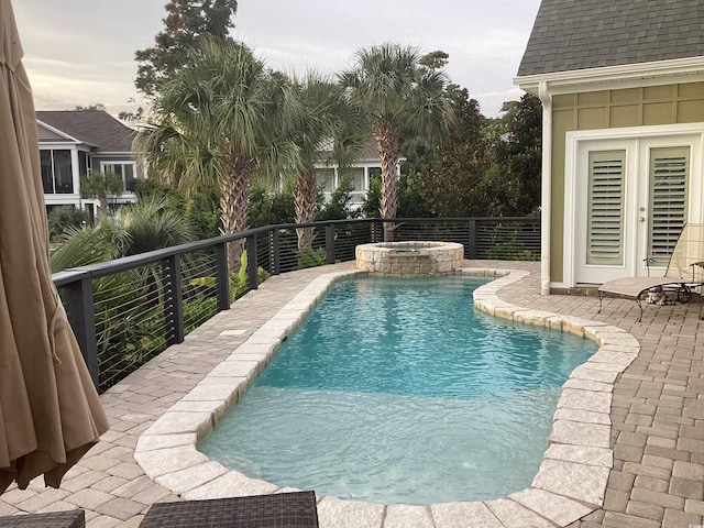 view of pool featuring an in ground hot tub and a patio area