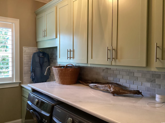 kitchen with backsplash and washing machine and clothes dryer