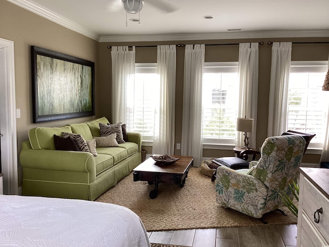 interior space featuring wood-type flooring, crown molding, and ceiling fan