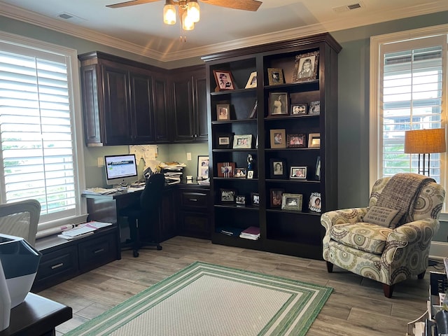 home office with ornamental molding, ceiling fan, and light hardwood / wood-style flooring