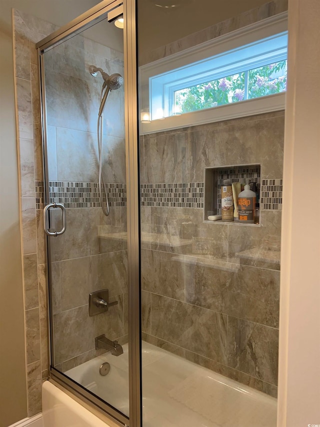 bathroom featuring shower / bath combination with glass door