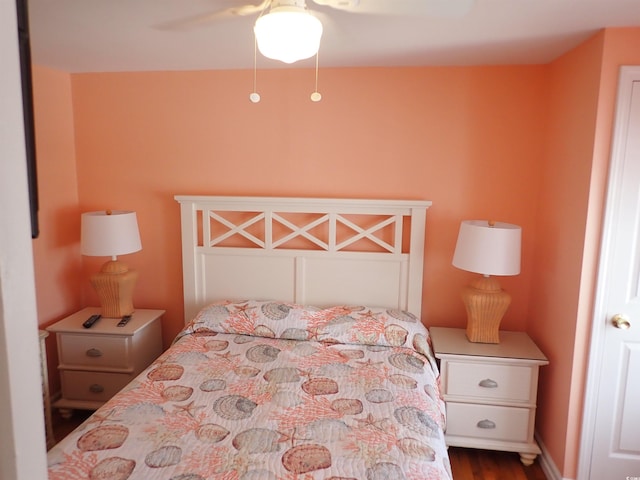 bedroom featuring ceiling fan and dark wood-type flooring