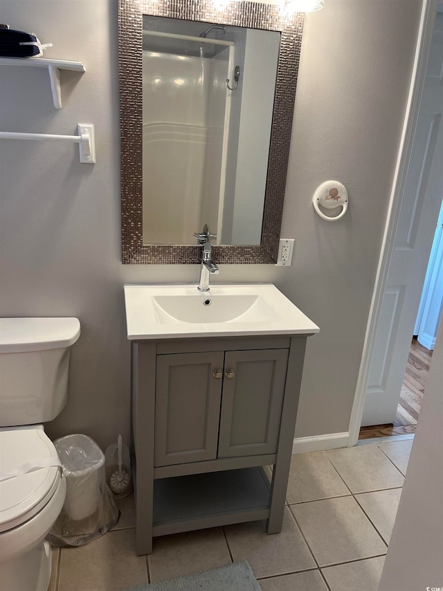 bathroom with walk in shower, tile patterned flooring, vanity, and toilet