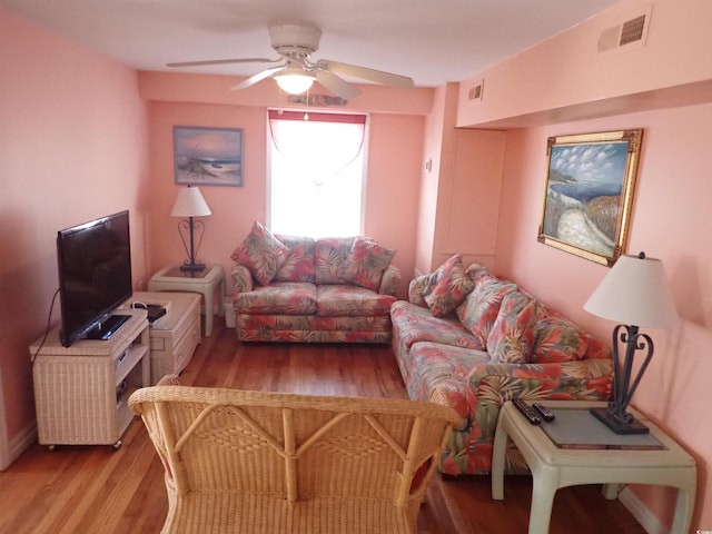 living room featuring light wood-type flooring and ceiling fan