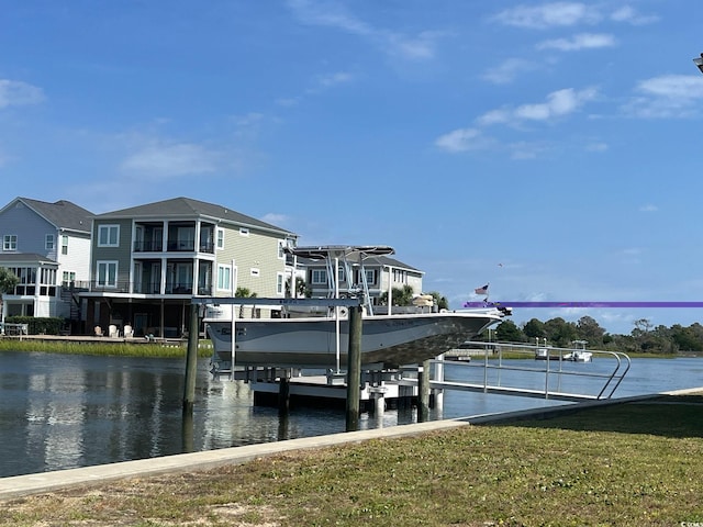 dock area with a water view and a yard