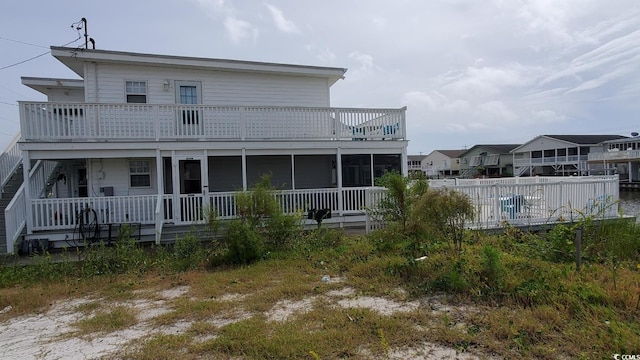 rear view of property featuring a pool