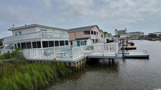 view of dock featuring a swimming pool side deck with water view