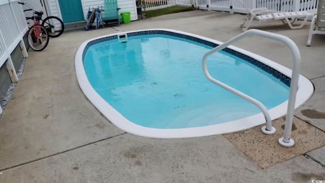 view of swimming pool with a patio