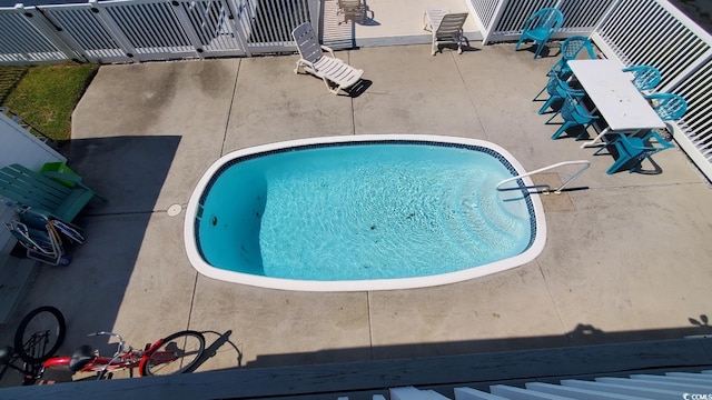 view of swimming pool featuring a patio area