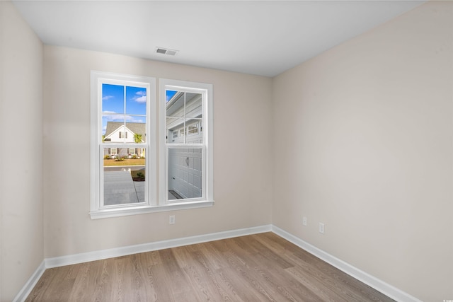 unfurnished room with light hardwood / wood-style flooring