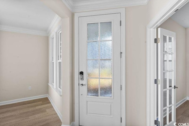 entryway featuring crown molding and hardwood / wood-style flooring