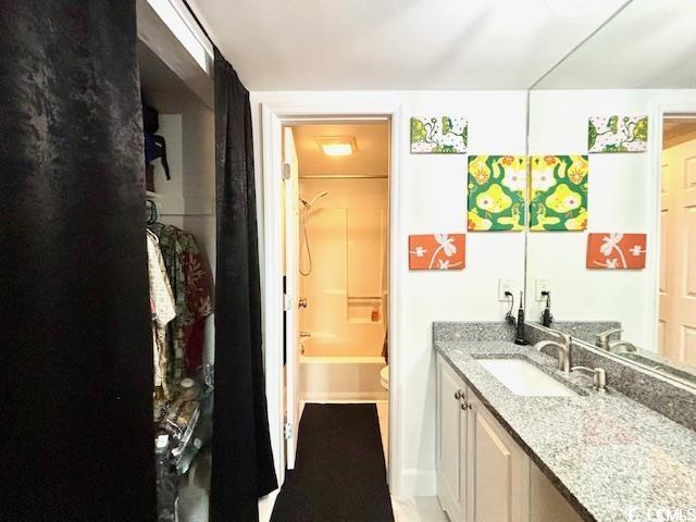 full bathroom featuring vanity, shower / washtub combination, and toilet