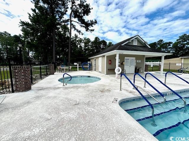 view of swimming pool featuring a community hot tub