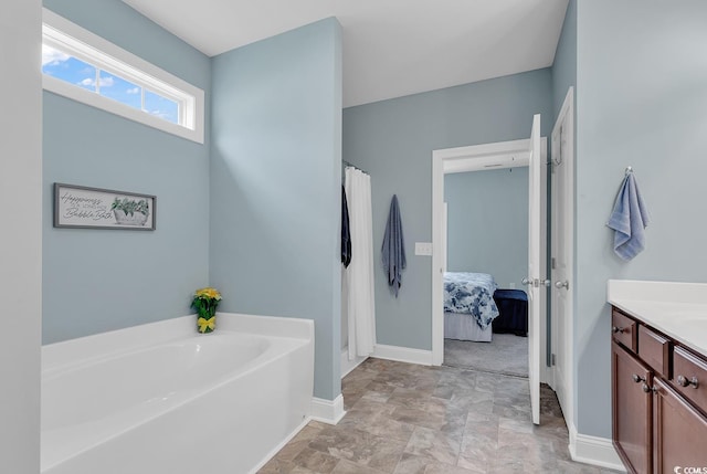full bath featuring a garden tub, ensuite bathroom, vanity, a shower with curtain, and baseboards