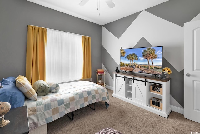 bedroom featuring baseboards, ceiling fan, and carpet