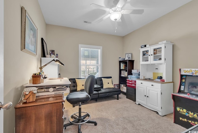 office area featuring visible vents, light colored carpet, and ceiling fan