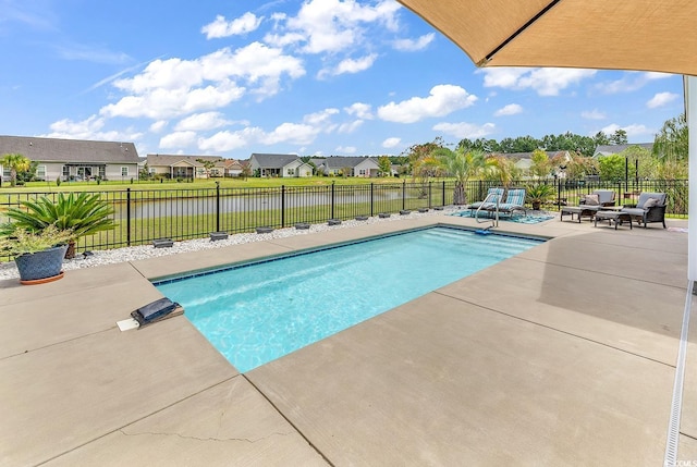 view of swimming pool featuring a fenced in pool, a patio, a residential view, a fenced backyard, and a water view