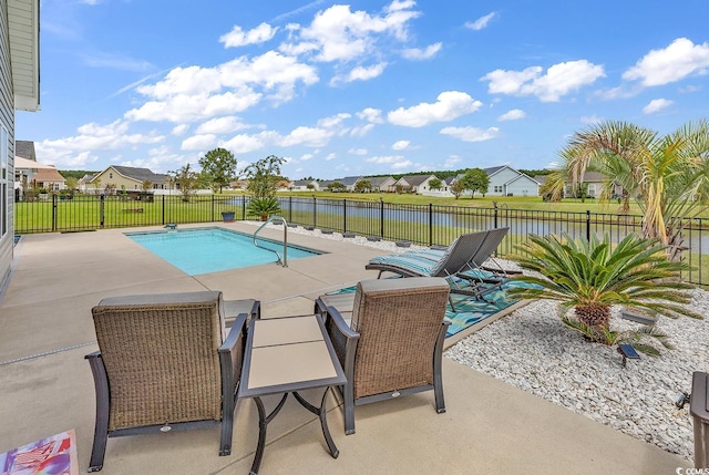 view of swimming pool featuring a fenced in pool, a patio area, a fenced backyard, and a residential view