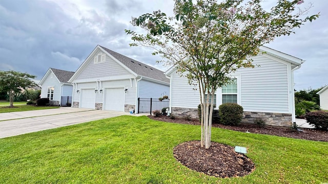 view of front of house with a front yard and a garage