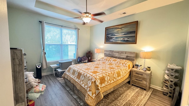 bedroom with wood-type flooring and ceiling fan