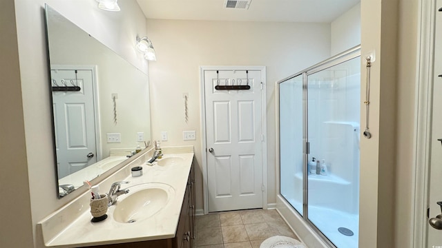 bathroom featuring tile patterned flooring, walk in shower, and vanity