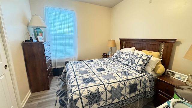 bedroom with hardwood / wood-style flooring