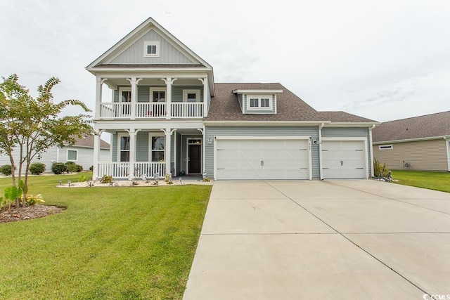 view of front of property featuring a garage, a front lawn, and a porch