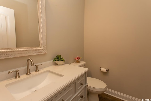 bathroom featuring hardwood / wood-style floors, vanity, and toilet