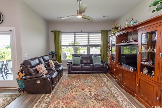 living room featuring ceiling fan, hardwood / wood-style flooring, and a healthy amount of sunlight