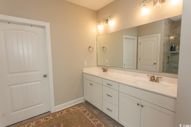 bathroom featuring tiled shower and vanity