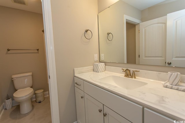 bathroom with vanity, toilet, and tile patterned floors