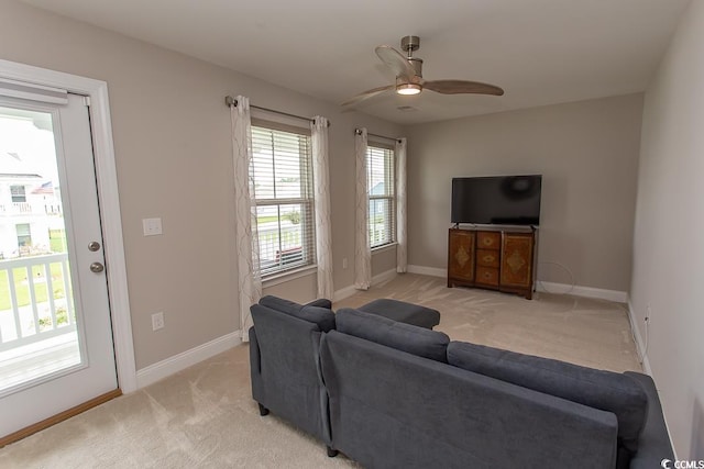 living room with light carpet and ceiling fan