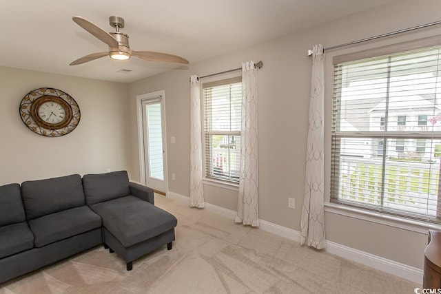 living room with ceiling fan and light colored carpet