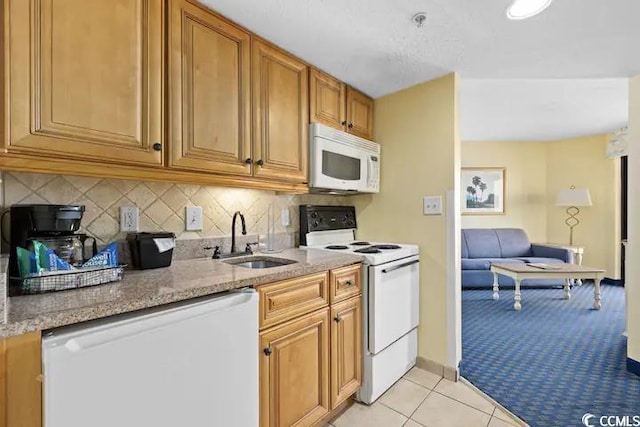 kitchen featuring sink, white appliances, light tile patterned floors, and tasteful backsplash