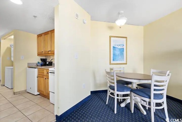 tiled dining room featuring sink