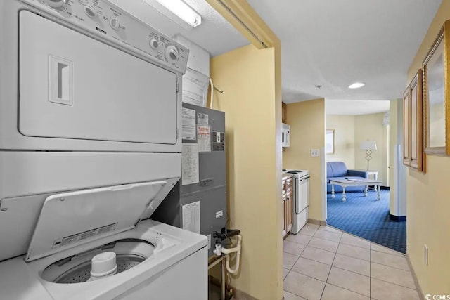 washroom with stacked washer / drying machine and light colored carpet