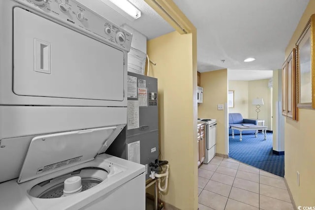 7100 Ocean Blvd N Unit 925, Myrtle Beach, SC 29572 - laundry area featuring stacked washer / dryer, light tile patterned floors, baseboards, light carpet, and recessed lighting