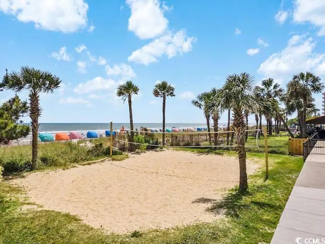 view of community with volleyball court and a water view