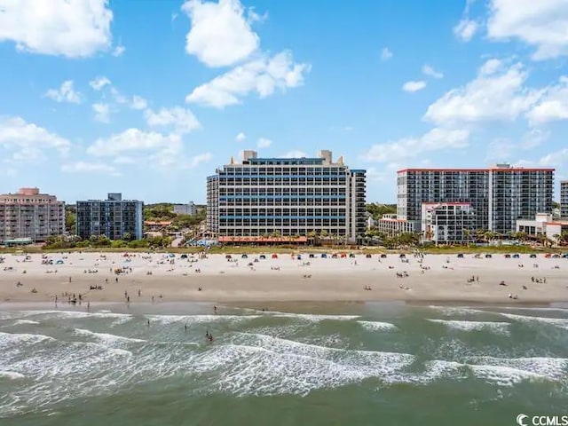 birds eye view of property with a view of the beach and a water view