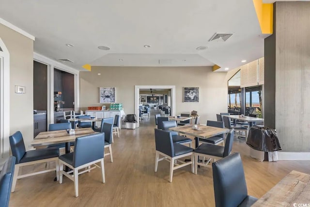 dining space with light wood-type flooring and lofted ceiling