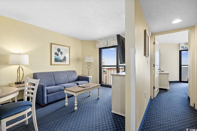 7100 Ocean Blvd N Unit 925, Myrtle Beach, SC 29572 - carpeted living area with a textured ceiling and baseboards